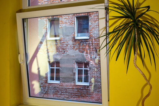 Fototapeta View from the window of an unrenovated house. Window next to a p