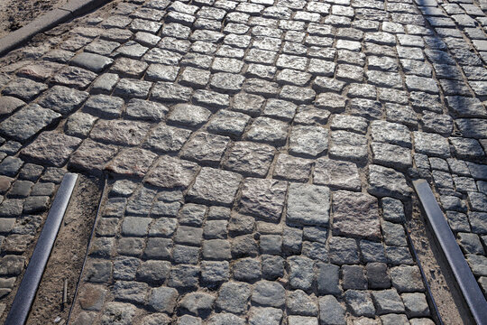 Old historic tram tracks end on a cobblestone street