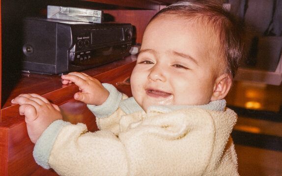 Analog photography of a smiling baby at home