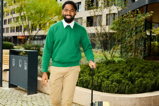 Happy man walks with a suitcase