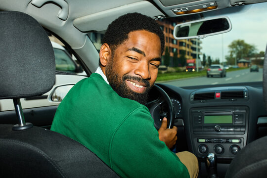 Man drives his car in the city