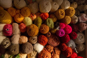 Colorful Yarn Collection Displayed on a Shelf in a Crafting Space