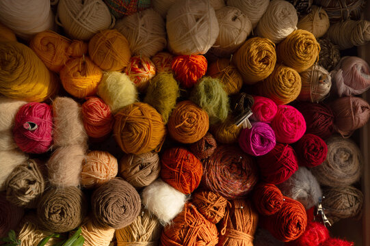 Colorful Yarn Collection Displayed on a Shelf in a Crafting Space
