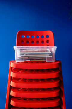 Bright Red Stacked Chairs With Clear Box Of Documents