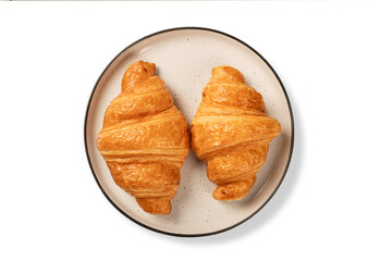 Two fresh croissant on circle ceramic plant isolated on white background. Top view
