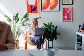Professional Woman With Laptop In Modern Office 