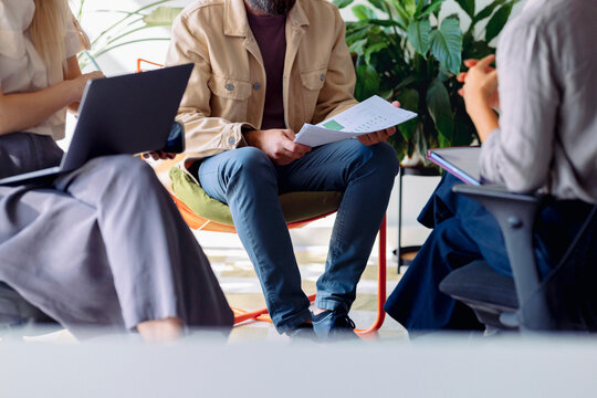 Casual Business Meeting With Papers And Laptop