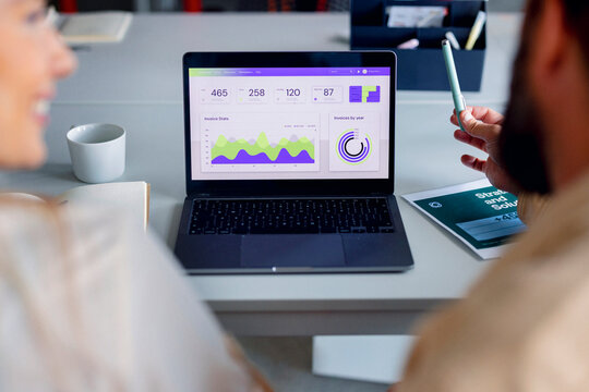 Collaborative Business Meeting Over Data Analytics On Laptop