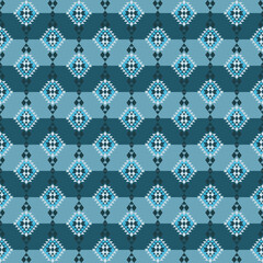 A high-contrast, all-over repeating pattern with a strong ethnic or tribal feel, built from nested rhombus and triangular geometric shapes in various shades of blue and teal.