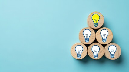Bright idea concept with illuminated light bulb atop wooden block stack