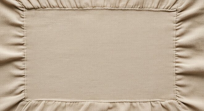 Rectangular piece of beige fabric features gathered ruffles around its perimeter.