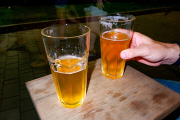 Cheers at a Nighttime Gathering With Drinks in a Lively Atmosphere