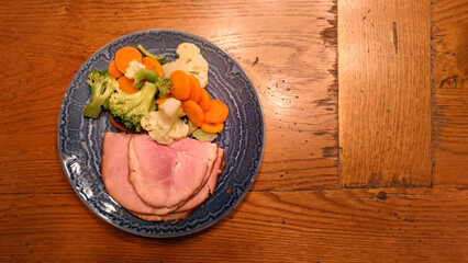 plate of sliced smoked ham with mixed vegetables  