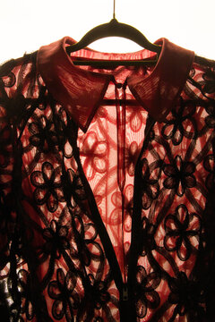 Detailed floral lace garment showcased against a light background
