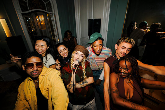 Diverse friends enjoying live music performance at party