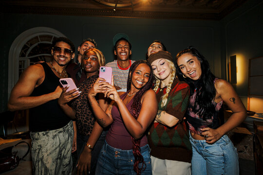 Diverse friends capturing moment and sharing happiness with selfie