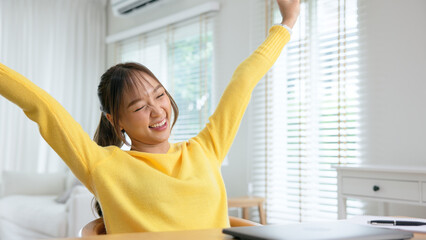 Gen Z teen asian workforce work hybrid workplace. Young adult asia people finish job done close laptop joy fun happy dance after take a break time from learn online study class at home digital nomad.