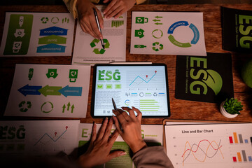Business colleagues analyzing esg data during corporate meeting