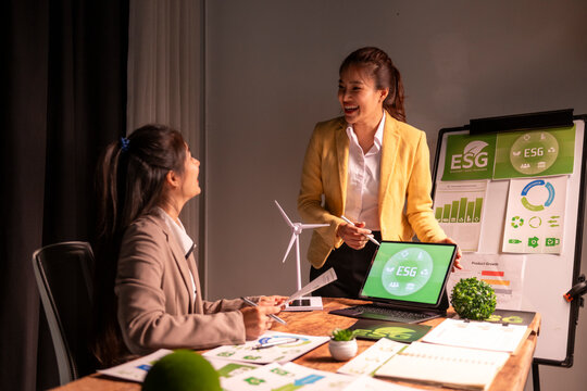 Businesswomen discussing esg strategy integrating sustainability and green energy