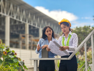 Women engineers planning construction project on site