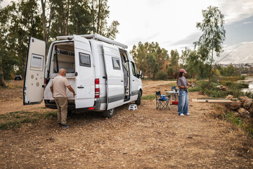 Father and daughter fishing together by the river