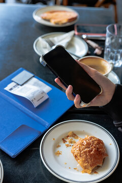 Paying the bill at a cafe with a phone.