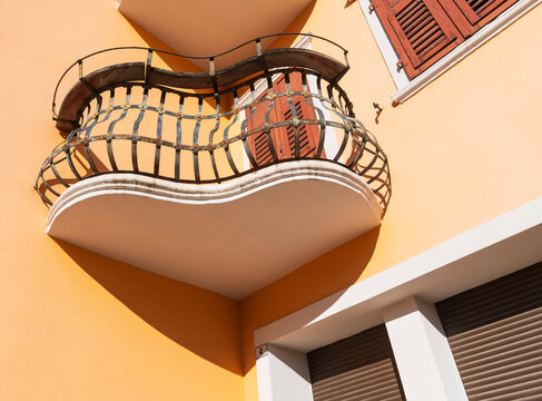 Heart Shaped Balcony on Orange Building in Sunlight