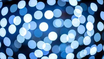 Blue bokeh lights with blurred circles on black.