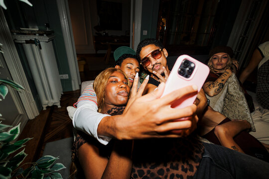 Diverse friends taking a selfie at a vibrant party