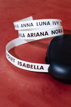 a label printer with baby girl names on a red surface