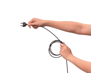 Close-up of hand holding a black electric power cord plug isolated on transparent PNG.