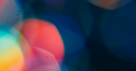 Bokeh light. Lens flare. Defocused blue orange yellow colorful round rainbow texture glimmer optical glint on art abstract background.