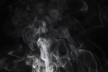 Dense White Smoke Swirling on Dark Background Abstract Vapor Clouds Rising in Soft Dramatic Light
