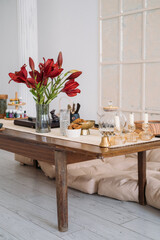 Dining room. Home atmosphere. Transparent teapot glass with tasty wholegrain snack candles bell for sound oil aromatherapy flower placed on table.
