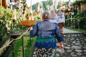 Balinese Woman Carrying Offering Basket During Galungan in Penglipuran Village