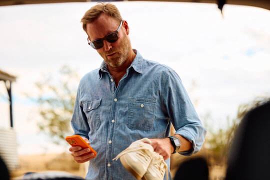 Attractive man packs his belongings