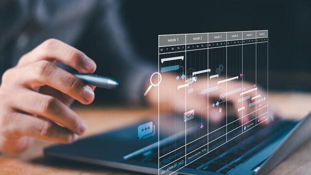 A professional interacting with a laptop displaying a holographic project timeline, illustrating time management, scheduling, task planning, and workflow organization in a modern digital workspace.