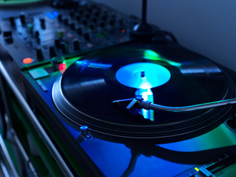 Spinning Vinyl Record on a Turntable in a Dimly Lit Room