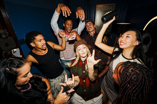 Diverse young adults enjoying music and dancing at party