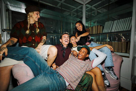 Diverse friends enjoying house party laughing together indoors