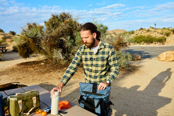 Man packs his stuff in a backpack