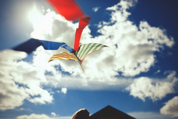 Colorful kites flying in a bright blue sky