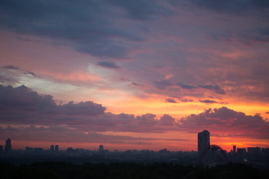 Colorful sunset over city skyline 