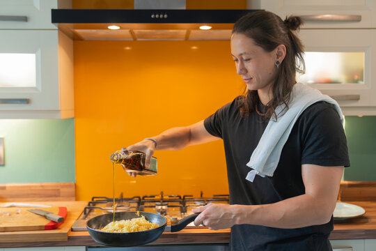 Man adds Extra Vergin Olive oil to his Homemade Italian Pasta dish