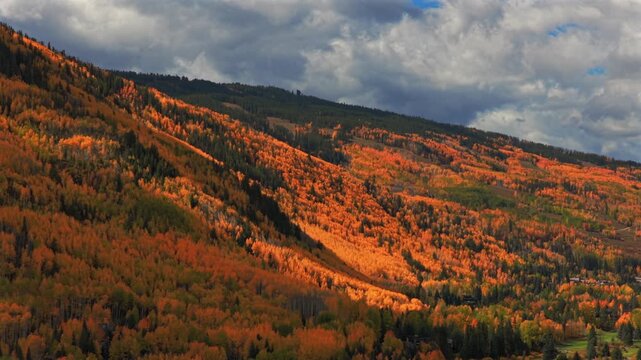 Vail Valley Vail Village Ski Resort trails Avon aerial drone Colorado fall autumn Rocky Mountains hillside cliffs quaking Aspen Trees morning blue sky cliffs Piney Ranch circle right parallax motion