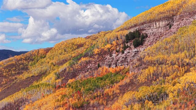 Vail Valley Vail Village Avon Beaver Creek Vail Pass aerial drone Colorado fall autumn Rocky Mountains hillside cliffs quaking Aspen Trees morning blue sky cliffs Piney Ranch forward pan up motion