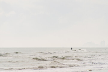 Paddleboarder on calm ocean waves