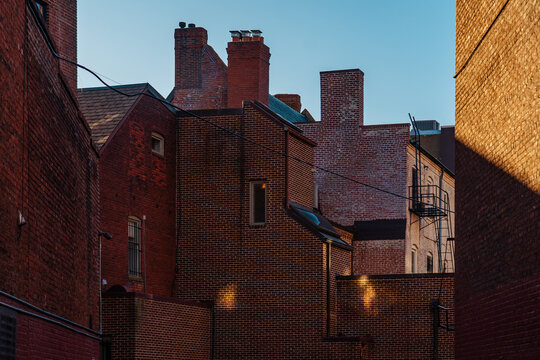 Brick alley with chimneys and fire escape