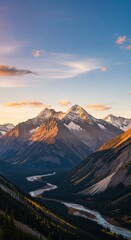 Fototapeta premium Towering, snow-capped peaks illuminate above a winding river in a deep valley during sunrise