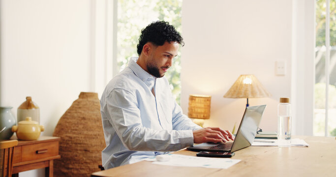 Laptop, remote work and typing with business man in home office for feedback, research or review. Computer, planning and reading with freelance employee at desk in apartment for startup proposal - Powered by Adobe